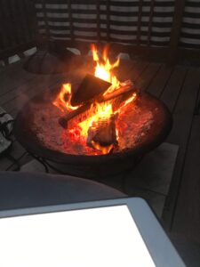 An ipad facing difficulty on top of a fire pit.