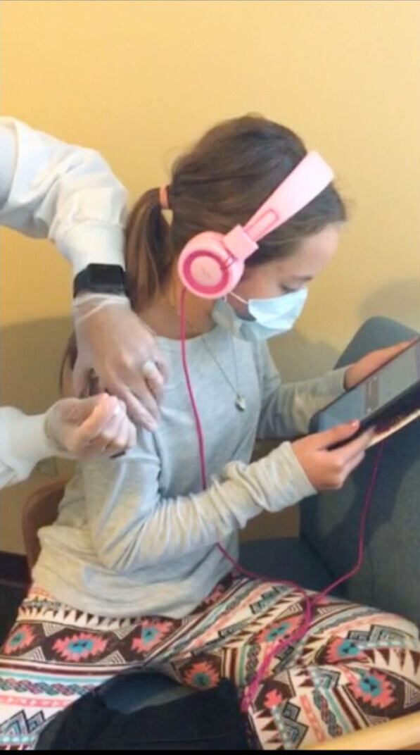 Yong girl calmly getting a shot in the arm - pediatric hypnosis success!